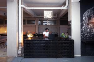 a woman sitting at a desk with a laptop at WALLYARD CONCEPT HOSTEL Berlin in Berlin