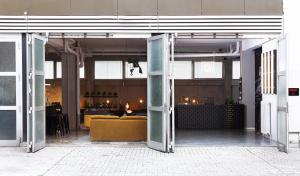 an open door of a building with a yellow couch at WALLYARD Stay in Berlin