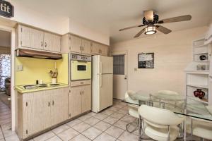 a kitchen with a glass table and a dining room at Golf Course and Pool Access Quaint Sun City Home in Sun City