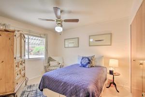 a bedroom with a bed and a ceiling fan at Golf Course and Pool Access Quaint Sun City Home in Sun City