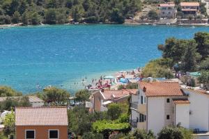 a view of a beach with people in the water at Apartments with a parking space Grebastica, Sibenik - 4866 in Grebaštica