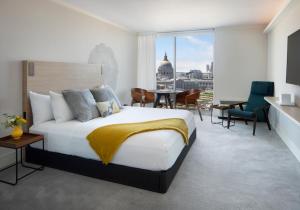 a bedroom with a bed and a view of the city at BEI San Francisco, Trademark Collection by Wyndham in San Francisco