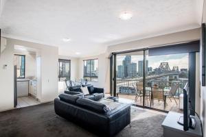 a living room with a couch and a large window at Bridgewater Apartments in Brisbane