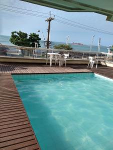 a swimming pool with a view of the ocean at Vila Costeira1402 BEIRA MAR Fortaleza in Fortaleza