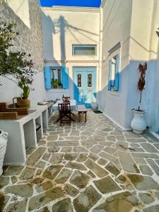 a room with a stone floor and blue and white walls at Aetheria traditional house in Koskinou