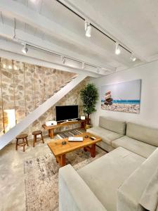 a living room with a couch and a table at Aetheria traditional house in Koskinou +79 photos