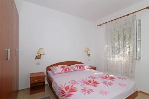 a bedroom with a bed and a window at Apartments by the sea Polace, Mljet - 613 in Polače