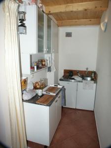 a small kitchen with white cabinets and a counter top at Apartments by the sea Pomena, Mljet - 614 in Pomena