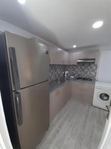 a kitchen with a stainless steel refrigerator and a stove at Dar salah in Hammamet