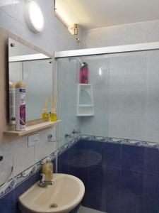 a bathroom with a sink and a shower with a mirror at Apartamento Quintas de San Javier in Medellín