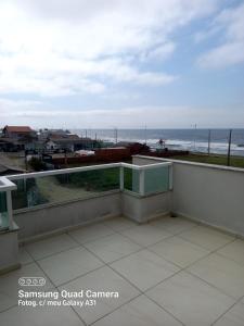 a balcony with a view of the ocean at Pousada Souza & Souza in Barra Velha