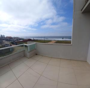 a balcony with a view of the ocean at Pousada Souza & Souza in Barra Velha