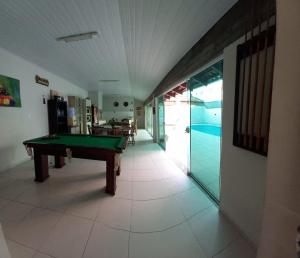 a hallway with a pool table in a house at Pousada Souza & Souza in Barra Velha