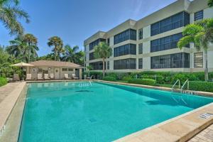 a swimming pool in front of a building at Luxury Sanibel Condo with Ocean View Steps to Beach in Sanibel