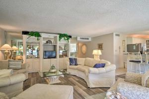 a living room with two couches and a tv at Luxury Sanibel Condo with Ocean View Steps to Beach in Sanibel