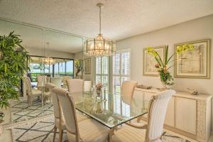 a dining room with a glass table and chairs at Luxury Sanibel Condo with Ocean View Steps to Beach in Sanibel