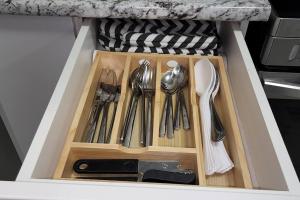 a drawer filled with utensils in a kitchen at QUIET & COZY MODERN SUITE CLOSE TO RCMP in Regina