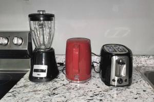 a blender and a toaster sitting on a kitchen counter at QUIET & COZY MODERN SUITE CLOSE TO RCMP in Regina