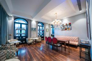 a living room with a table and chairs at Gracie Art Hotel in Beijing