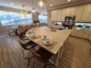 a large kitchen with a table and chairs in it at New Lovely Home at Sonoma Resort at Tapestry in Kissimmee