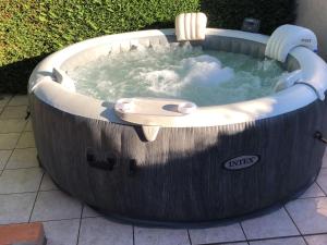 a jacuzzi tub in a garden with a bathtubificialificialificial at Cozy Holiday Home in Piquecos with Private Swimming Pool in Piquecos