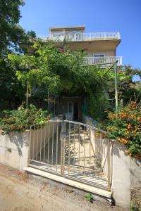 a gate in front of a house with flowers at Apartments by the sea Viganj, Peljesac - 633 in Viganj