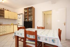 a kitchen with a table and chairs and a refrigerator at Apartments by the sea Viganj, Peljesac - 633 in Viganj
