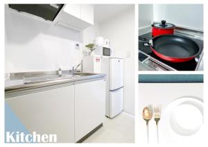 a kitchen with a sink and a stove with a pan on it at nestay apartment tokyo ginza in Tokyo