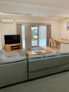 a living room with a couch and a table at Seahorse Motel Cowes in Cowes