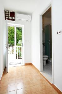 an empty hallway with a bathroom with a toilet at Apartments by the sea Brna, Korcula - 574 in Smokvica
