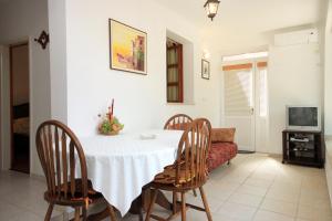 a dining room with a table and chairs and a couch at Apartments by the sea Brna, Korcula - 574 in Smokvica