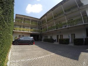 a black car parked in front of a building at Hotel Sampurna Cirebon in Cirebon