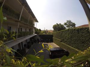 a car parked on a street next to a building at Hotel Sampurna Cirebon in Cirebon