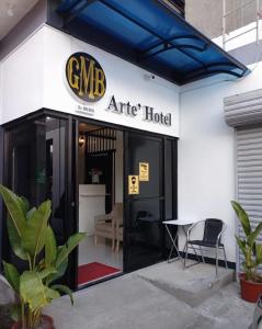 an entrance to an office hotel with a table outside at Gmb-Arte' Hotel in Sogod