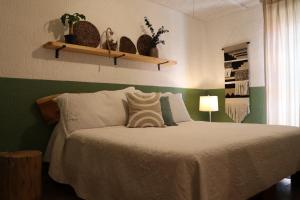 a bedroom with a bed and shelves with plants at CASA MADERA in Lagos de Moreno