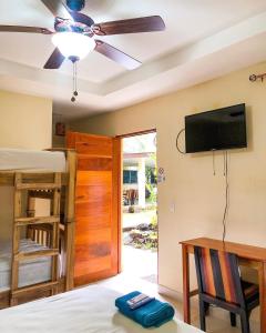 a bedroom with a bed and a flat screen tv at Casa Inti Guesthouse & Lodge in Managua