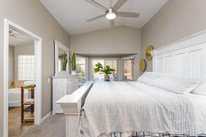 une chambre avec un grand lit blanc et une salle de bain dans l'établissement Casa De Mojave home, à Scottsdale 33 autres photos