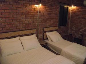 Postel nebo postele na pokoji v ubytování Brick Box Hotel @ Oldtown Ipoh