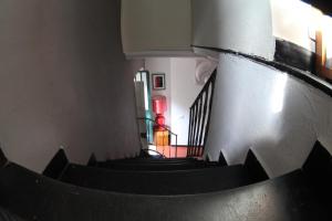 a spiral staircase in a building with a person in the background at BBQ Lodge in Camogli