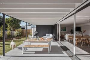 a living room with a couch and a table at Sanctuary Spaces - Lomani Eleven in Byron Bay