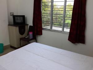 מיטה או מיטות בחדר ב-Lodge Lipika
