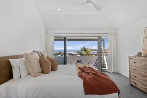 a bedroom with a bed with a view of the ocean at Pacific Piers in Coffs Harbour