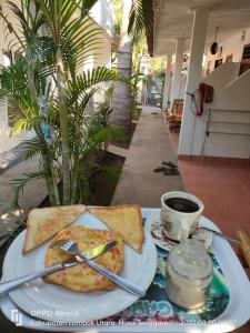 a plate of food with toast and a cup of coffee at H.Said Homestay in Gili Trawangan