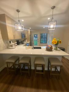 a kitchen with a large counter with four stools at South Montezuma Properties LLC in Prescott