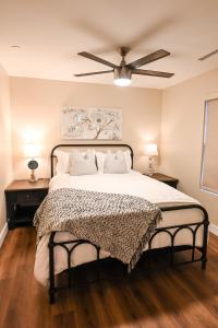 a bedroom with a large bed with a ceiling fan at South Montezuma Properties LLC in Prescott