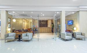 a lobby with chairs and a table in a building at Аврора Wellness & SPA Hotel in Chelyabinsk