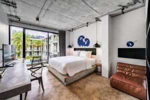 a bedroom with a bed and a desk at Kokotel Khao Lak Lighthouse in Khao Lak