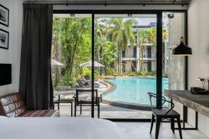 a hotel room with a view of a swimming pool at Kokotel Khao Lak Lighthouse in Khao Lak