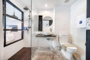 a bathroom with a toilet and a sink and a shower at Kokotel Khao Lak Lighthouse in Khao Lak