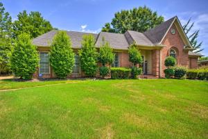 a house with a green lawn in front of it at Comfortable and Pleasant 4 Bedroom Home in Memphis